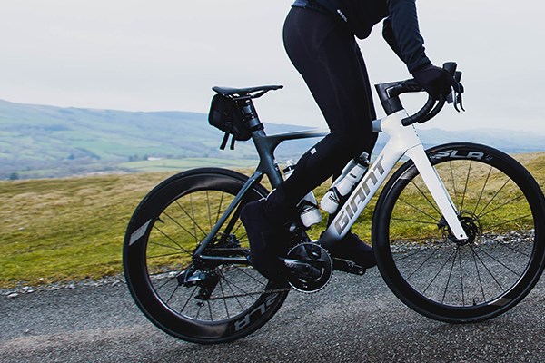 Giant propel climbing a hill with a saddle bag